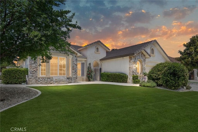 2403 Crocus Dr, Bakersfield, CA 93311 - ranch-style house featuring stone siding, a front yard, stucco siding, a garage, and concrete driveway
