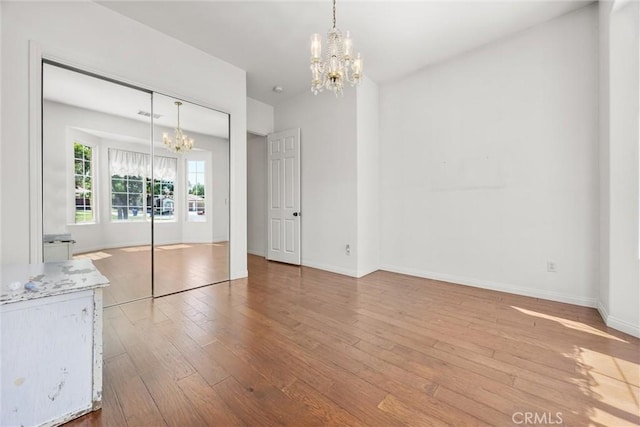 2403 Crocus Dr, Bakersfield, CA 93311 - unfurnished bedroom with a chandelier, hardwood / wood-style flooring, baseboards, and a closet