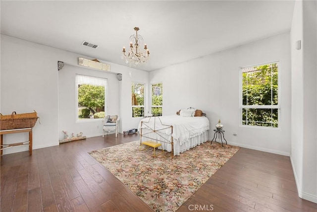 2403 Crocus Dr, Bakersfield, CA 93311 - bedroom with multiple windows, a chandelier, and wood-type flooring