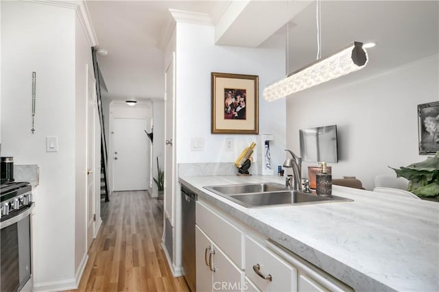 28729 Conejo View Dr, Agoura Hills, CA 91301 - kitchen featuring stainless steel appliances, a sink, ornamental molding, light countertops, and light wood finished floors