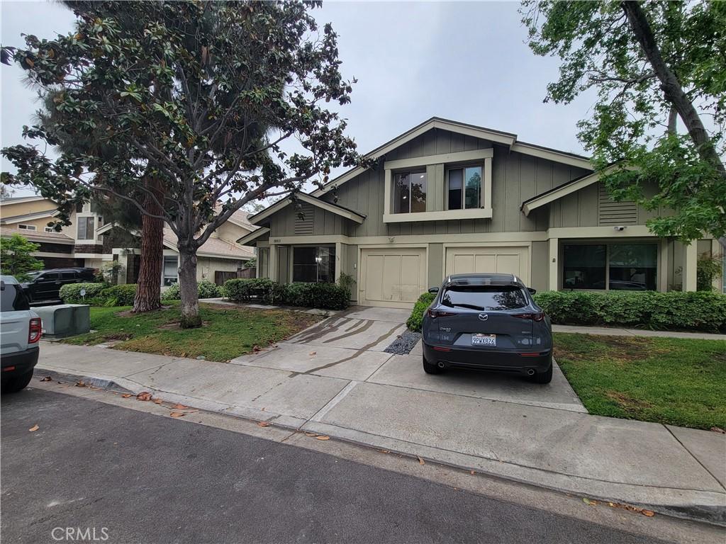 3683 Cactusview Dr, San Diego, CA 92105 - view of front of property with concrete driveway, a garage, and board and batten siding