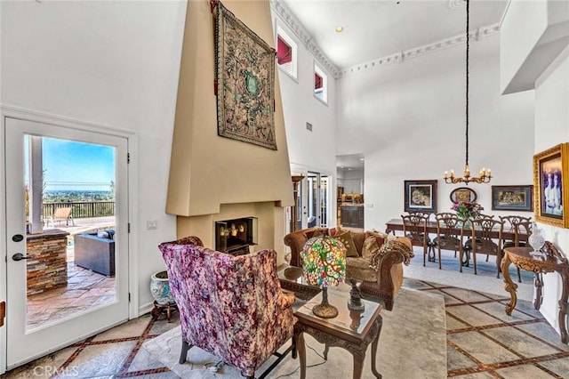 1532 Kensing Ln, North Tustin, CA 92705 - living area with a towering ceiling, healthy amount of natural light, a chandelier, and a warm lit fireplace