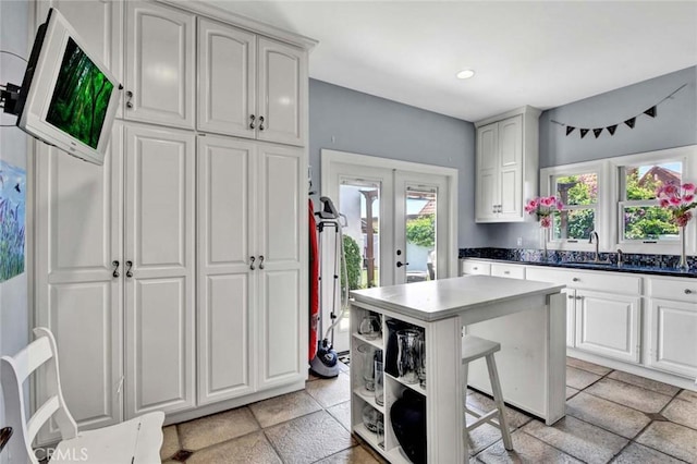 1532 Kensing Ln, North Tustin, CA 92705 - kitchen featuring a sink, french doors, a kitchen bar, a kitchen island, and open shelves