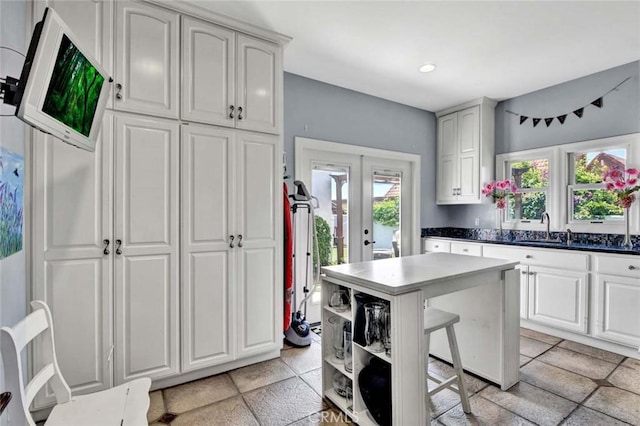 1532 Kensing Ln, North Tustin, CA 92705 - kitchen featuring french doors, a breakfast bar area, a kitchen island, open shelves, and dark countertops