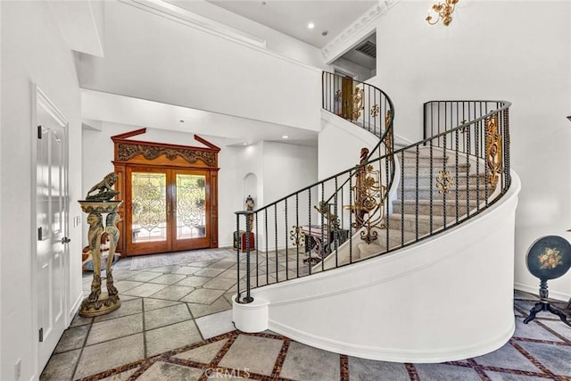1532 Kensing Ln, North Tustin, CA 92705 - foyer with inlaid floor details, french doors, arched walkways, stairs, and a towering ceiling
