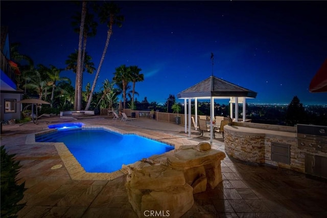 1532 Kensing Ln, North Tustin, CA 92705 - pool at night featuring a gazebo, exterior kitchen, a patio, and a pool with connected hot tub