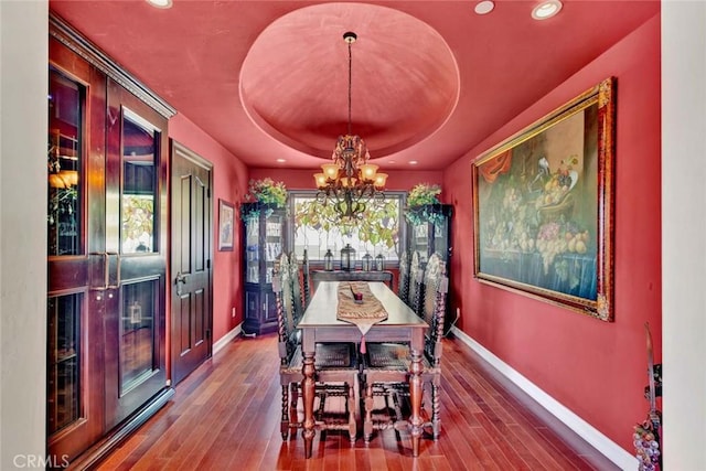 1532 Kensing Ln, North Tustin, CA 92705 - dining area featuring a chandelier, baseboards, a tray ceiling, hardwood / wood-style flooring, and recessed lighting