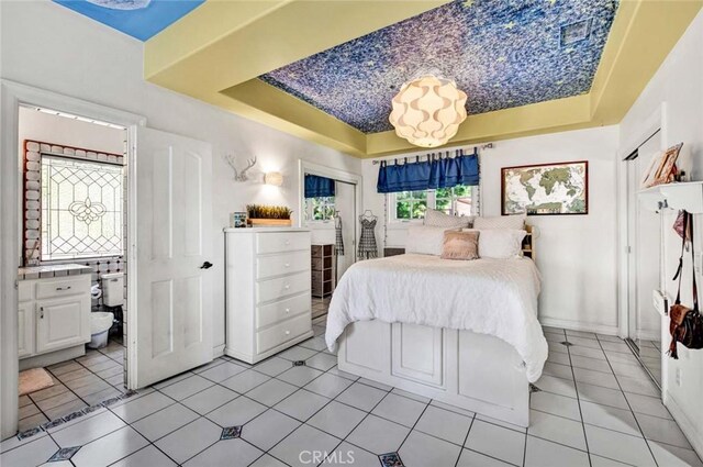 1532 Kensing Ln, North Tustin, CA 92705 - bedroom featuring a raised ceiling, light tile patterned floors, and ensuite bathroom