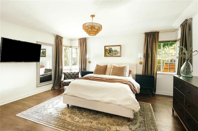 2319 S Corning St, Los Angeles, CA 90034 - bedroom featuring dark wood-style floors, baseboards, and a chandelier