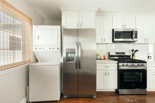 2319 S Corning St, Los Angeles, CA 90034 - kitchen with stainless steel appliances, stacked washer / dryer, healthy amount of natural light, and dark wood-type flooring
