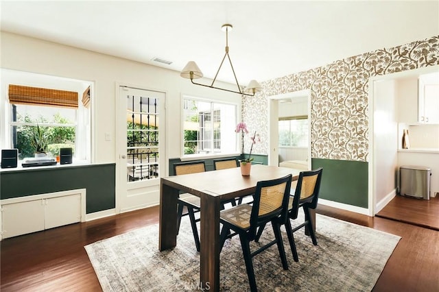 2319 S Corning St, Los Angeles, CA 90034 - dining space with wallpapered walls, baseboards, and wood finished floors