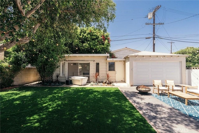 2319 S Corning St, Los Angeles, CA 90034 - back of house featuring a fire pit, stucco siding, and a garage