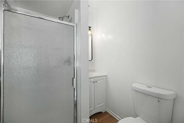 45110 Elm Ave, Lancaster, CA 93534 - full bathroom featuring vanity, a shower stall, toilet, and wood finished floors