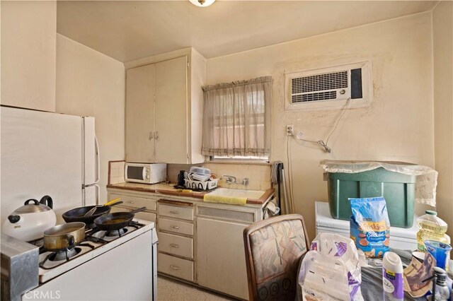 45110 Elm Ave, Lancaster, CA 93534 - kitchen featuring white appliances, an AC wall unit, and tasteful backsplash
