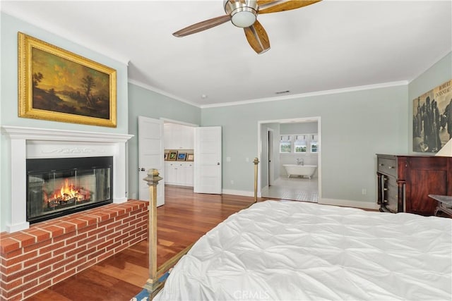 36475 Avenida La Cresta, Murrieta, CA 92562 - bedroom with wood finished floors, ornamental molding, a brick fireplace, baseboards, and connected bathroom