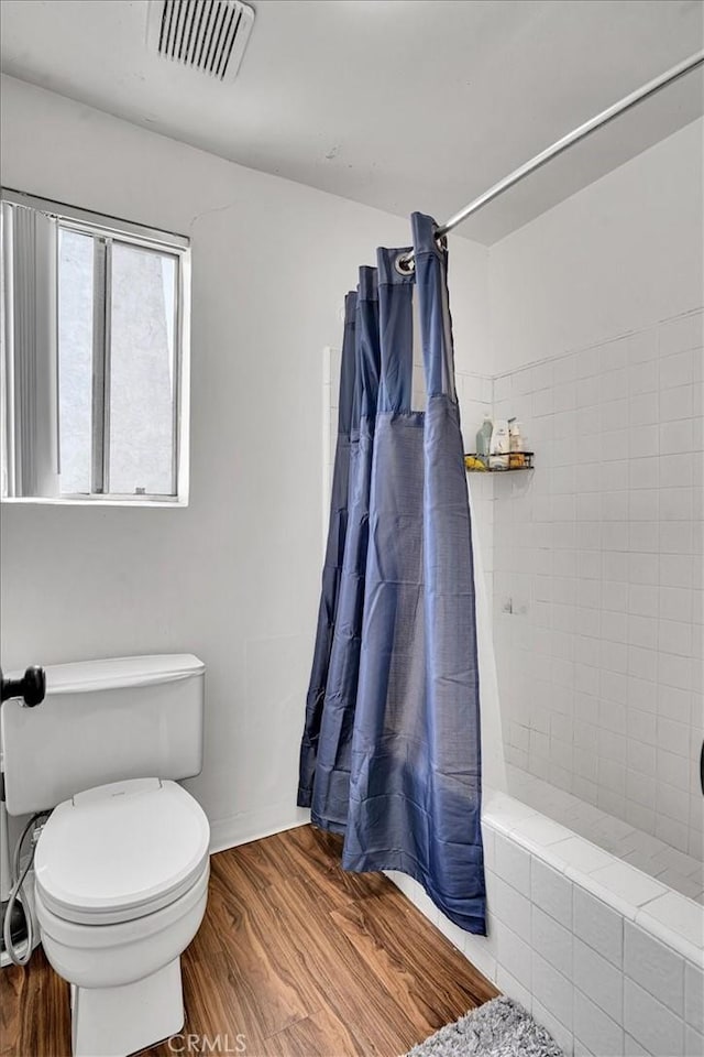 2212 Grant Ave, Redondo Beach, CA 90278 - full bath with tiled shower, wood finished floors, and toilet