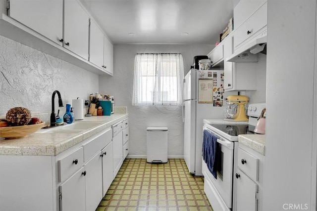 2212 Grant Ave, Redondo Beach, CA 90278 - kitchen with white appliances, light flooring, a sink, light countertops, and a textured wall