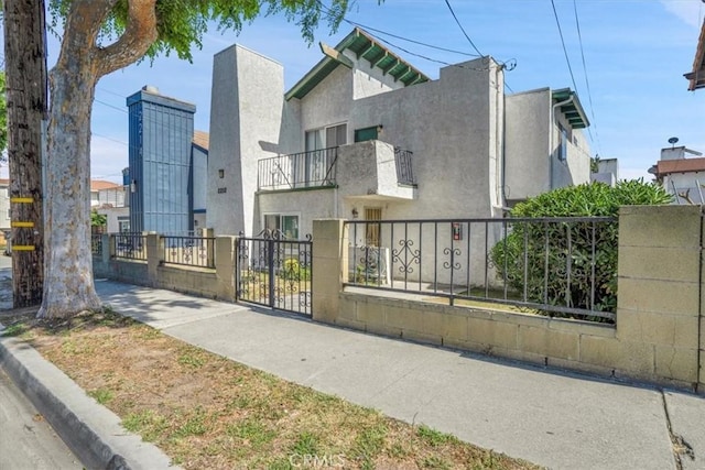 2212 Grant Ave, Redondo Beach, CA 90278 - view of front of home featuring a fenced front yard, stucco siding, and a balcony