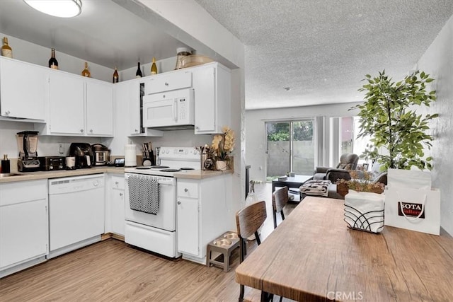 2212 Grant Ave, Redondo Beach, CA 90278 - kitchen featuring white appliances, a textured ceiling, light countertops, light wood-style floors, and white cabinetry