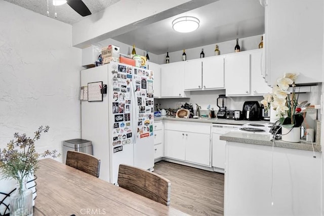 2212 Grant Ave, Redondo Beach, CA 90278 - kitchen featuring white appliances, white cabinets, light countertops, light wood finished floors, and a sink