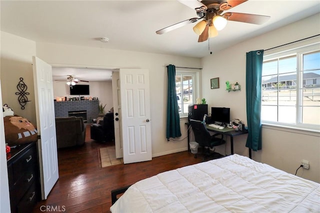 18353 Hackberry St, Hesperia, CA 92345 - bedroom featuring hardwood / wood-style floors, a brick fireplace, baseboards, and a ceiling fan