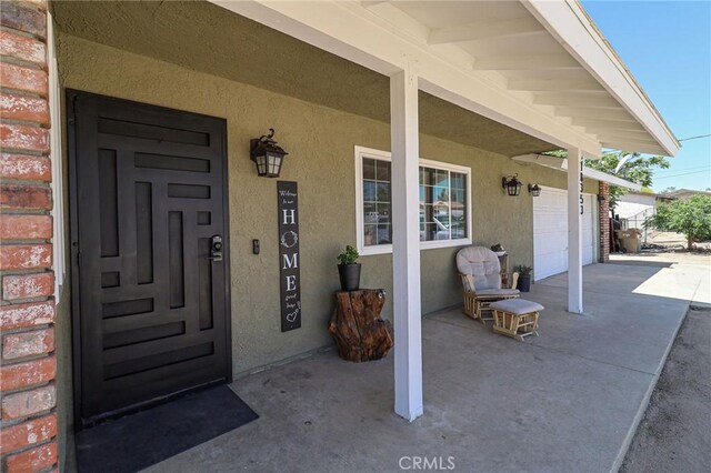 18353 Hackberry St, Hesperia, CA 92345 - doorway to property featuring stucco siding and a porch