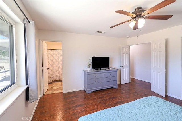 18353 Hackberry St, Hesperia, CA 92345 - bedroom featuring dark wood-type flooring, baseboards, ceiling fan, and ensuite bath