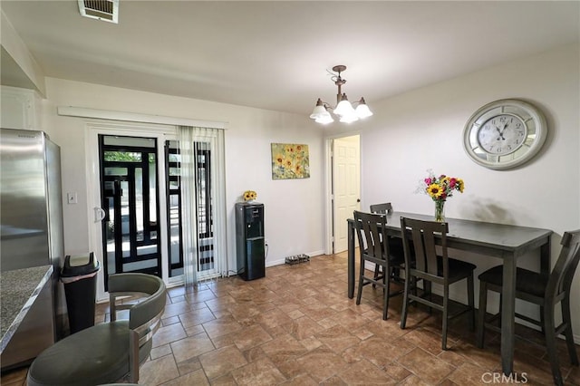 18353 Hackberry St, Hesperia, CA 92345 - dining space with dark stone finish flooring, a chandelier, and baseboards