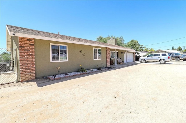 18353 Hackberry St, Hesperia, CA 92345 - ranch-style home featuring a garage, a chimney, and stucco siding