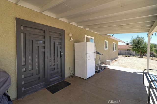 18353 Hackberry St, Hesperia, CA 92345 - property entrance with stucco siding and a patio area