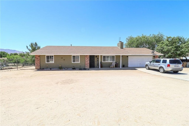 18353 Hackberry St, Hesperia, CA 92345 - ranch-style home with a garage, driveway, and a chimney
