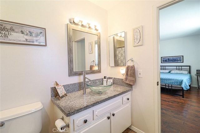 18353 Hackberry St, Hesperia, CA 92345 - bathroom featuring vanity, toilet, wood finished floors, and baseboards