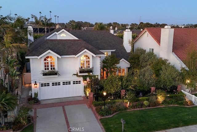 22372 Harwich Ln, Huntington Beach, CA 92646 - view of front of house featuring concrete driveway, stucco siding, a chimney, an attached garage, and a front lawn