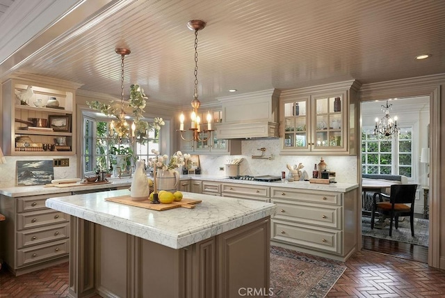 22372 Harwich Ln, Huntington Beach, CA 92646 - kitchen with a chandelier, light countertops, a kitchen island, gas cooktop, and crown molding