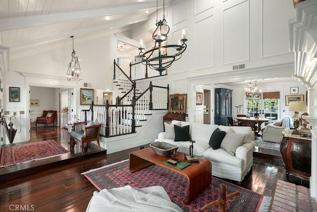 22372 Harwich Ln, Huntington Beach, CA 92646 - living room with a chandelier, a decorative wall, dark wood-type flooring, beam ceiling, and high vaulted ceiling