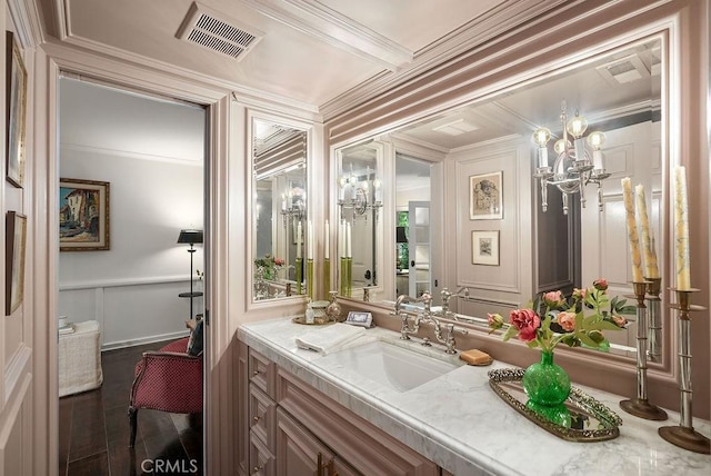 22372 Harwich Ln, Huntington Beach, CA 92646 - bathroom with a decorative wall, vanity, a chandelier, ornamental molding, and wood finished floors