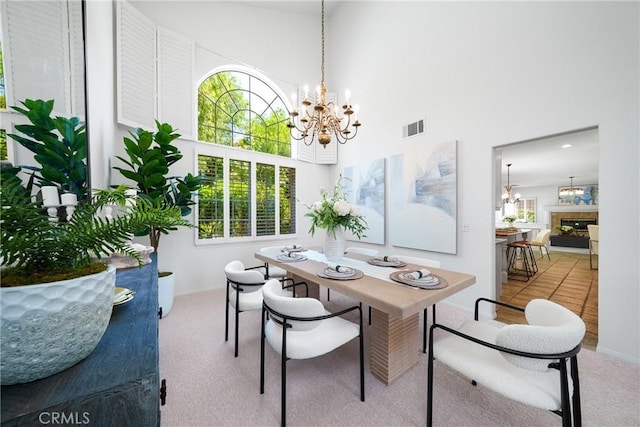 12800 N Overlook Dr, Rancho Cucamonga, CA 91739 - dining room featuring a chandelier, carpet floors, and a high ceiling