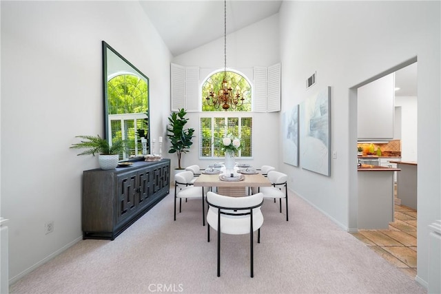 12800 N Overlook Dr, Rancho Cucamonga, CA 91739 - dining room with high vaulted ceiling, light colored carpet, baseboards, and a chandelier