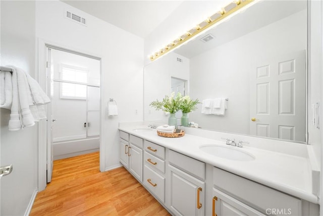12800 N Overlook Dr, Rancho Cucamonga, CA 91739 - full bathroom with double vanity, wood finished floors, and baseboards