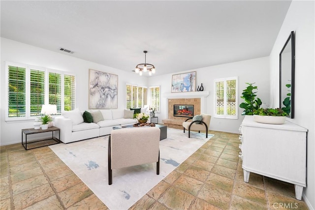 12800 N Overlook Dr, Rancho Cucamonga, CA 91739 - living area with stone tile flooring, a chandelier, a premium fireplace, and baseboards