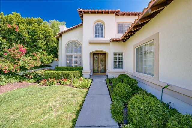 12800 N Overlook Dr, Rancho Cucamonga, CA 91739 - entrance to property with french doors, stucco siding, a chimney, a tile roof, and a yard
