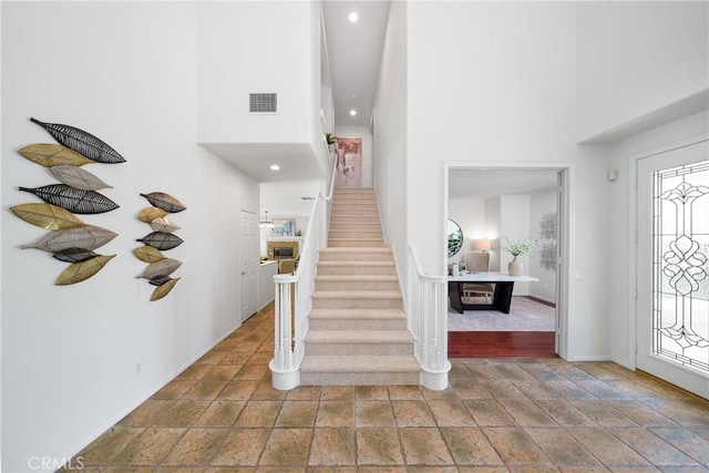 12800 N Overlook Dr, Rancho Cucamonga, CA 91739 - foyer featuring a towering ceiling, stairway, baseboards, stone finish floors, and recessed lighting