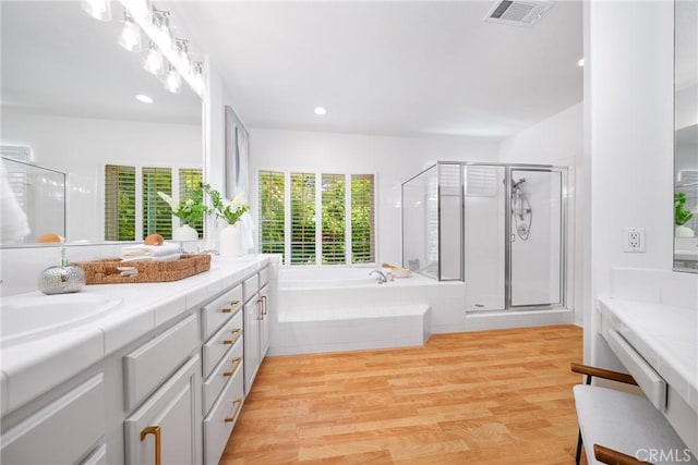 12800 N Overlook Dr, Rancho Cucamonga, CA 91739 - bathroom featuring plenty of natural light, double vanity, a bath, a shower stall, and recessed lighting