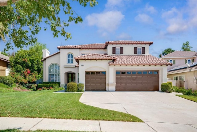 12800 N Overlook Dr, Rancho Cucamonga, CA 91739 - mediterranean / spanish home featuring driveway, a tile roof, a chimney, stucco siding, and a front lawn