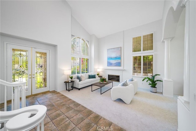 12800 N Overlook Dr, Rancho Cucamonga, CA 91739 - living area featuring french doors, high vaulted ceiling, decorative columns, and a glass covered fireplace