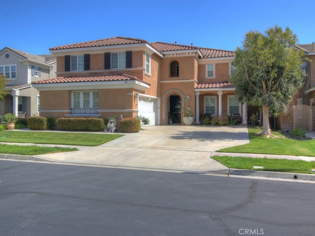 15585 Marnie Pl, Fontana, CA 92336 - mediterranean / spanish house with a tiled roof, stucco siding, an attached garage, and driveway