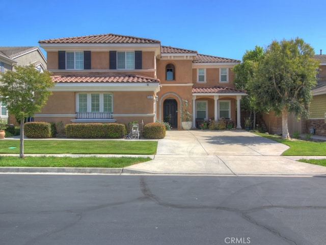 15585 Marnie Pl, Fontana, CA 92336 - mediterranean / spanish house featuring a tiled roof, stucco siding, a front yard, and concrete driveway