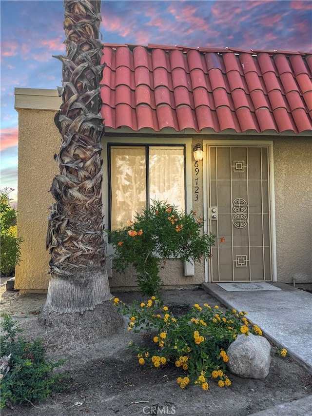 69723 Encanto Ct, Rancho Mirage, CA 92270 - doorway to property with a tiled roof and stucco siding