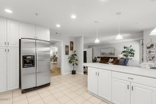 2735 Los Pinos Cir, Camarillo, CA 93012 - kitchen with stainless steel refrigerator with ice dispenser, open floor plan, light countertops, decorative light fixtures, and white cabinetry
