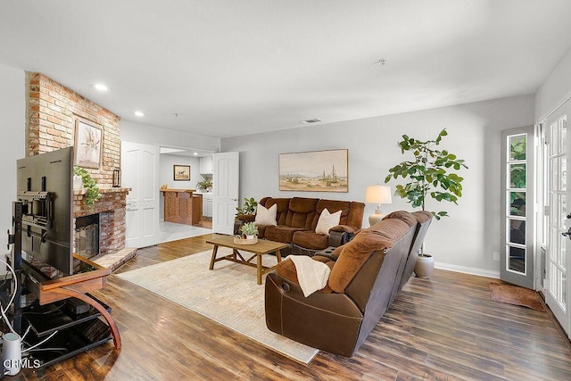 2735 Los Pinos Cir, Camarillo, CA 93012 - living area with wood finished floors, recessed lighting, baseboards, and a brick fireplace